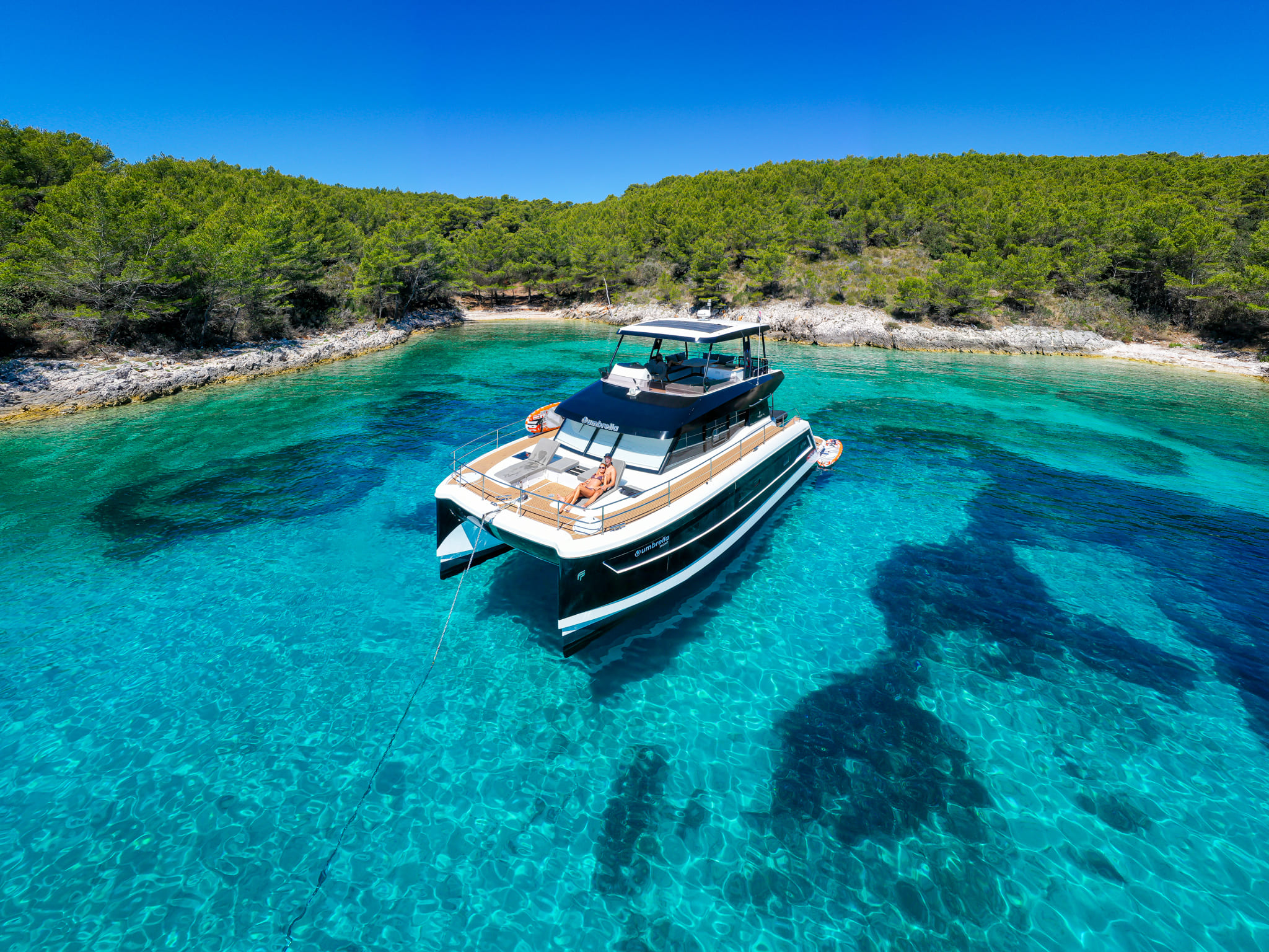 Catamaran anchored in a cove